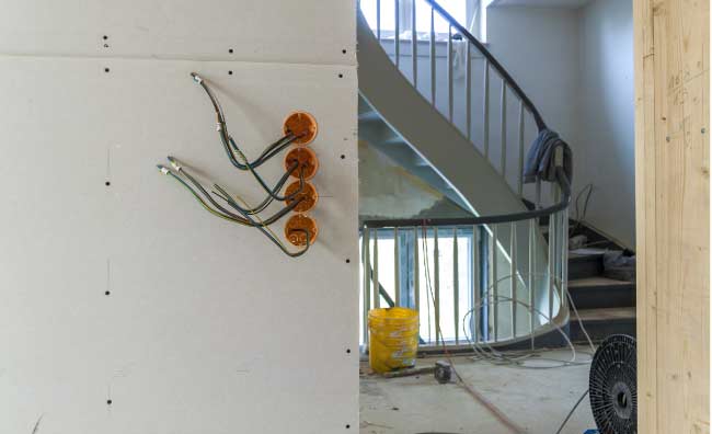 Electrician upgrading wiring during a home remodeling project in Visalia, CA