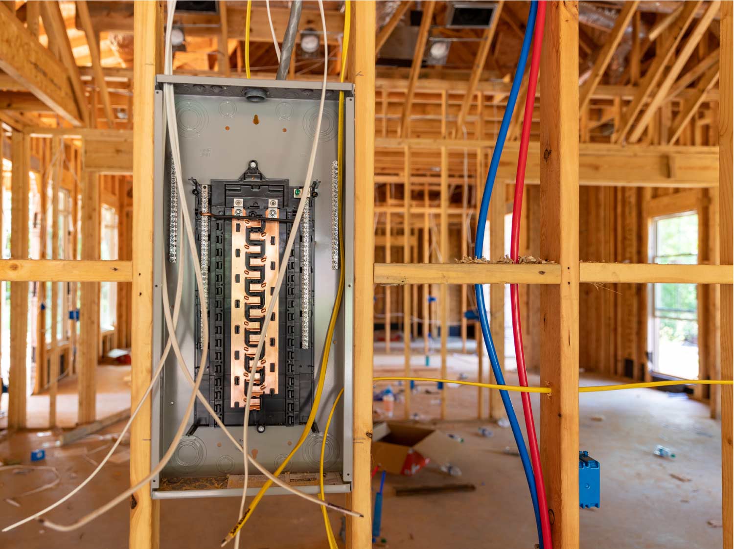 Tri-County-Electric Expert electrician installing a modern circuit breaker panel in a new construction home.