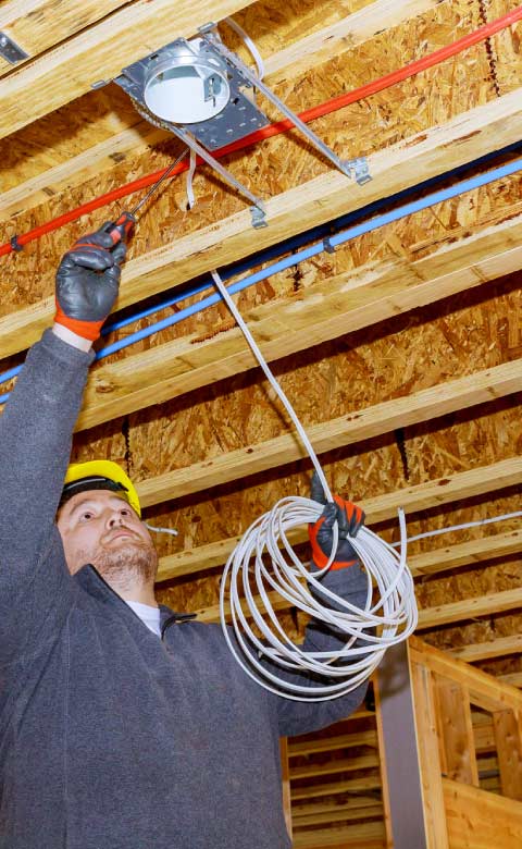 electrician-working Team of experienced electricians from Tri County Electric on-site at a local Fresno home.